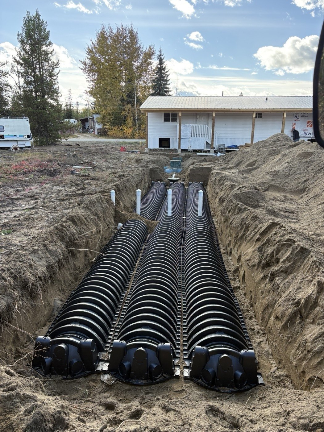 Rows of septic field chambers installed in an excavated bed at one of Tim’s projects
